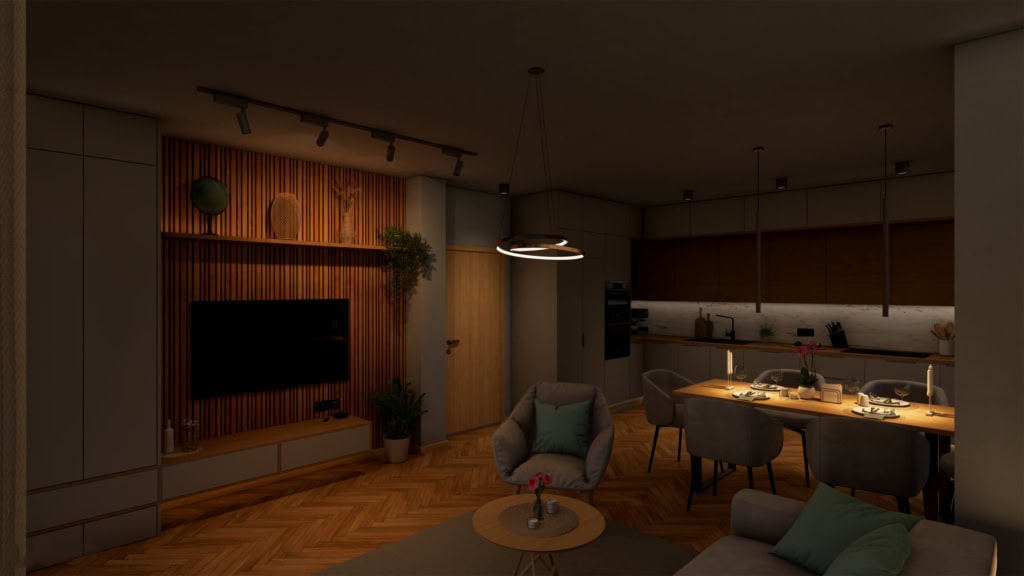 Večerní vizualizace obývacího pokoje a kuchyně. Místnost je útulně nasvícena teplým světlem z bodovek a designových lustrů. Dominantou je osvětlená televizní stěna s dřevěnými lamelami. V popředí je křeslo a pohovka, v pozadí prostřený stůl a kuchyň.